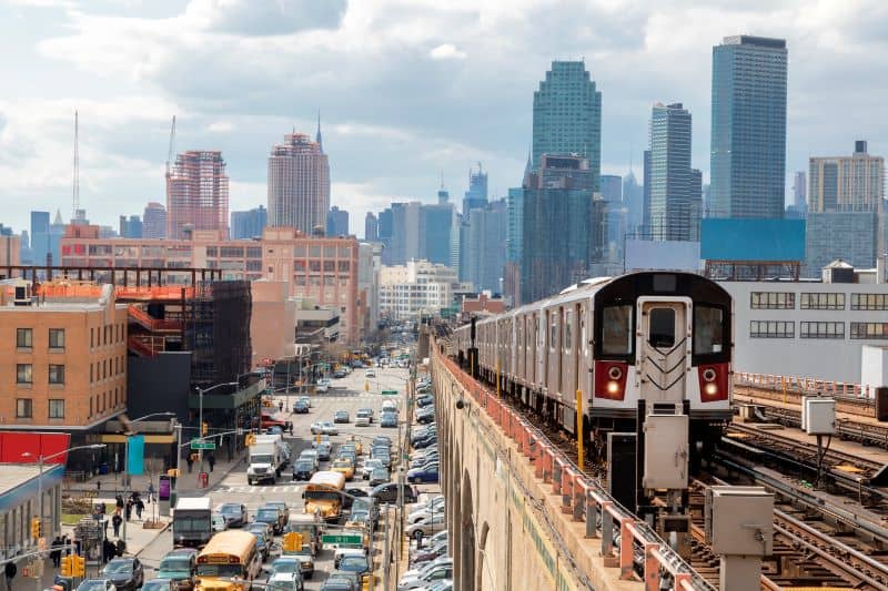 Train approaching elevated subway station in Queens, New York