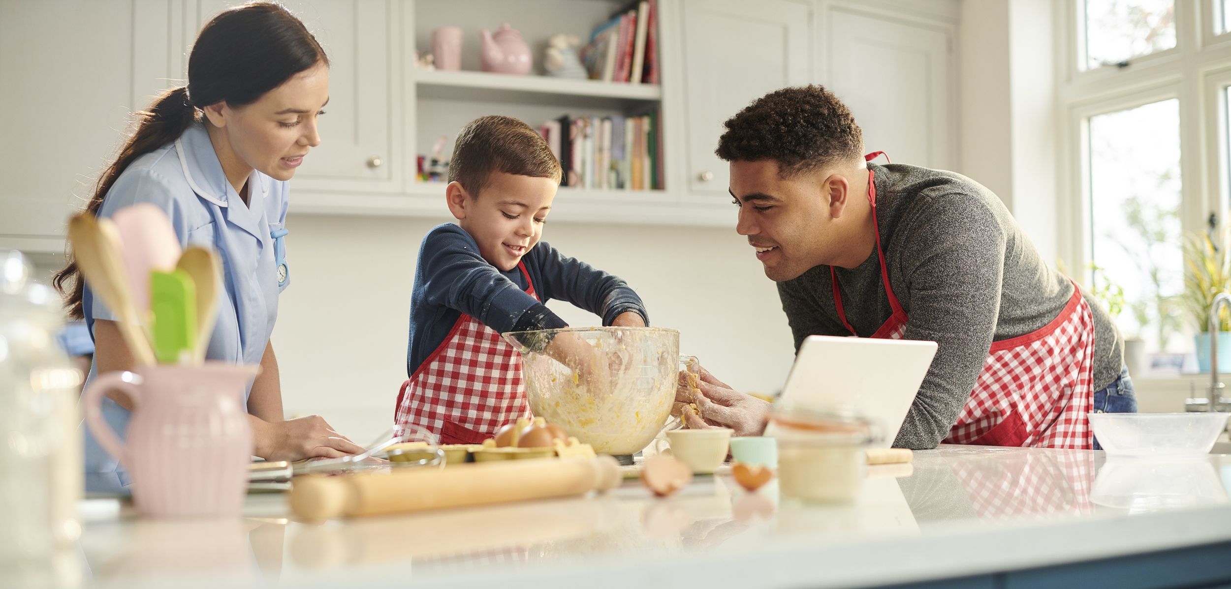 family making cookies in kitchen