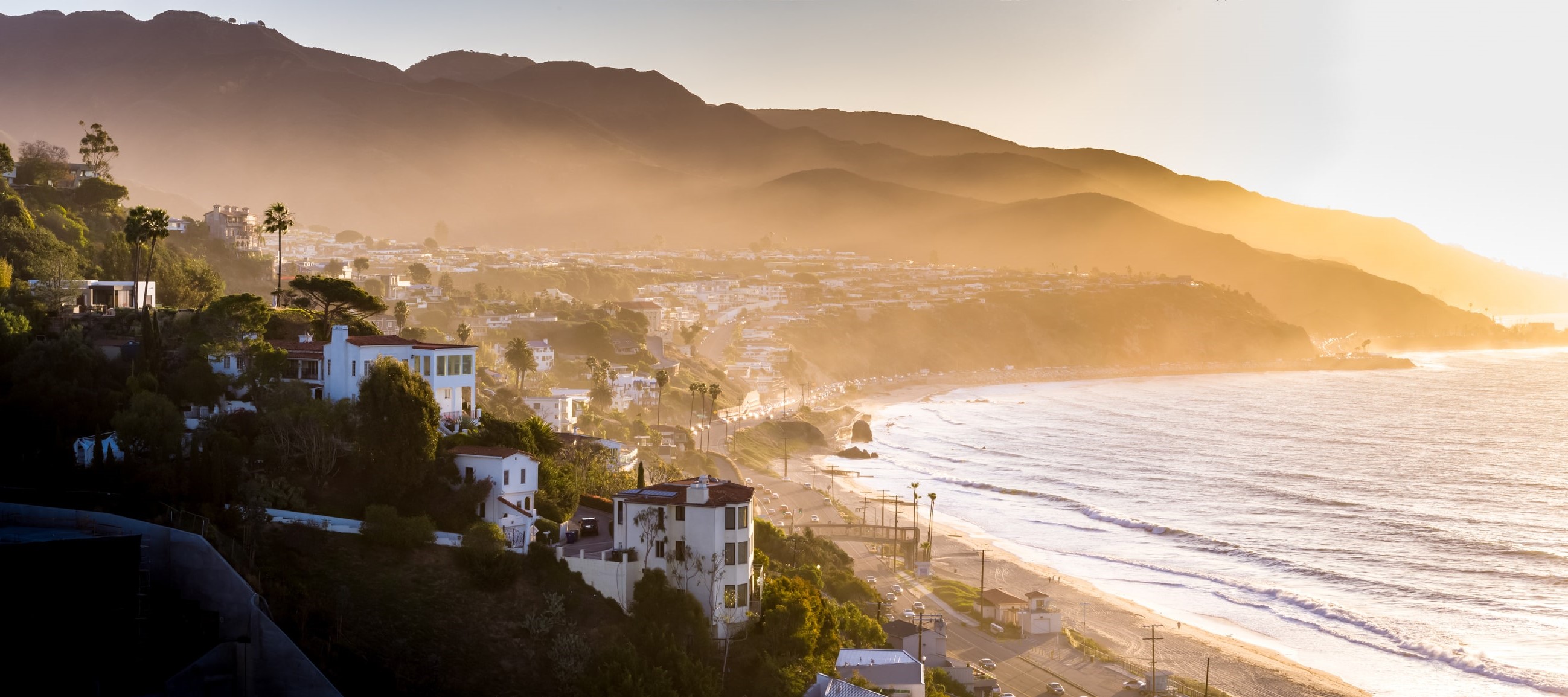 birdseye view of homes on hill overlooking california beach coast 