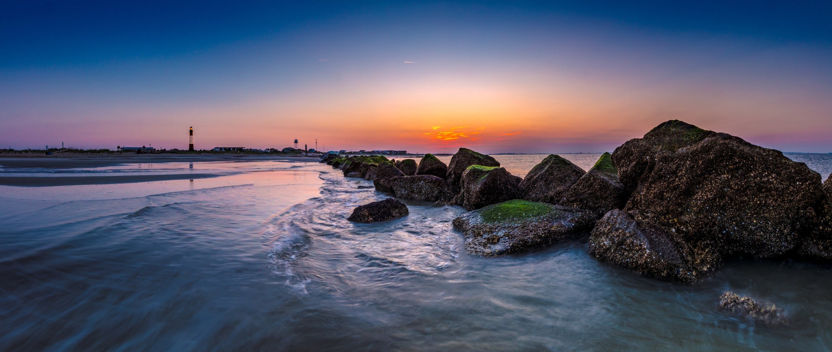 pink and orange sunset over tybee island beach front