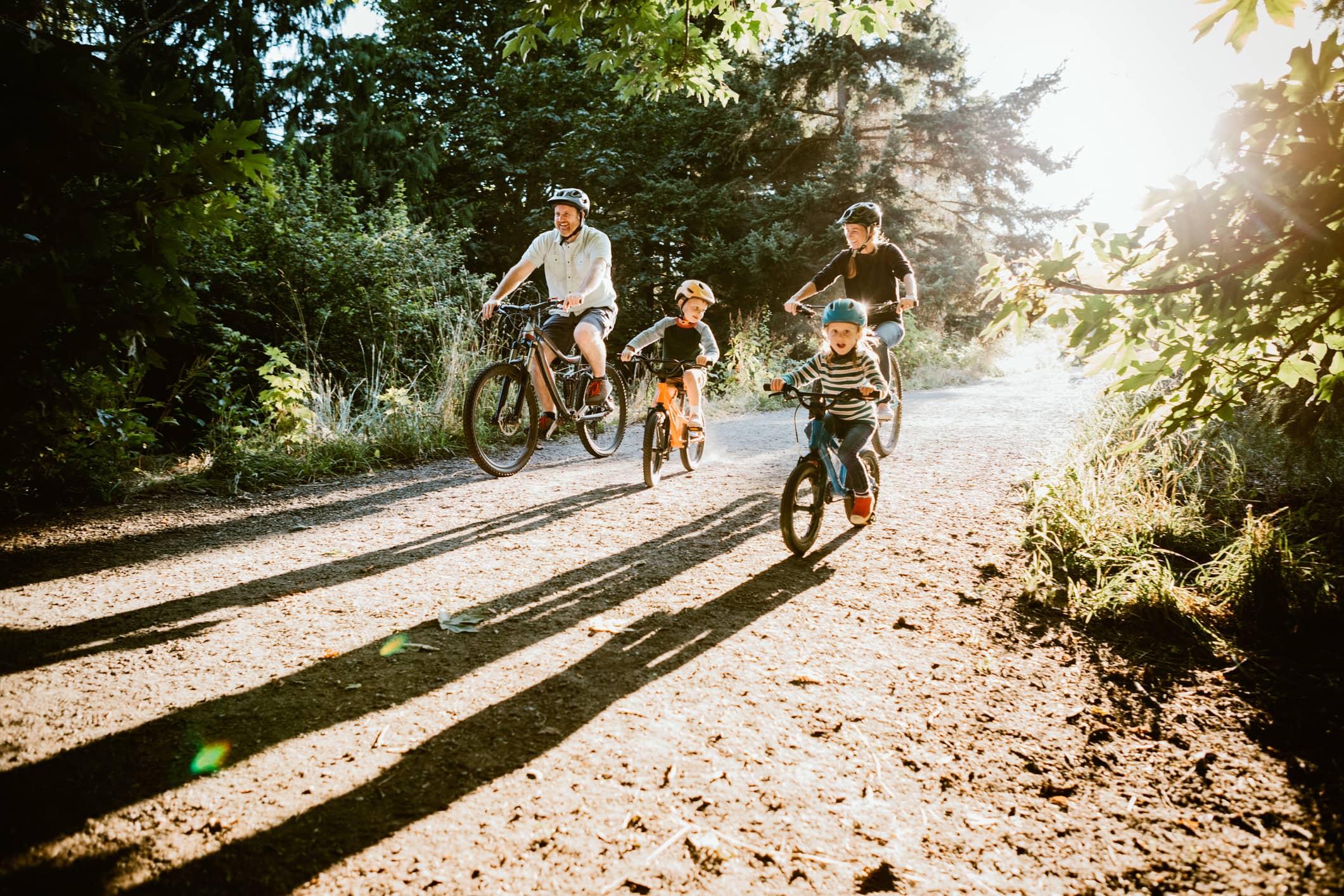 Man, woman, and children biking on Washington state trail